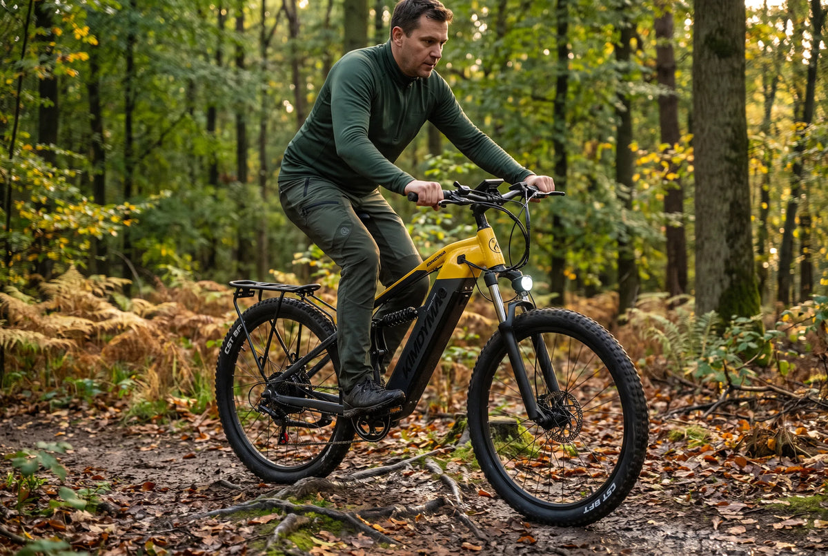 E-MTB rider on a wet autumn forest trail with roots and fallen leaves