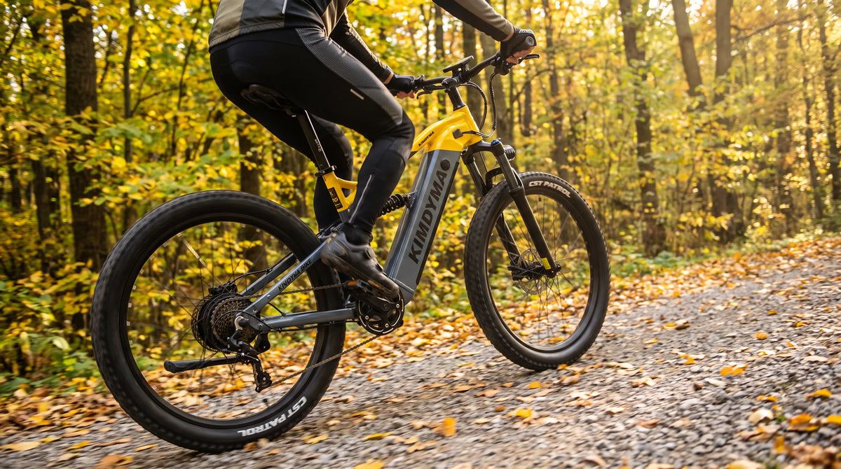 E-MTB rider braking on a steep forest descent with disc brake visible