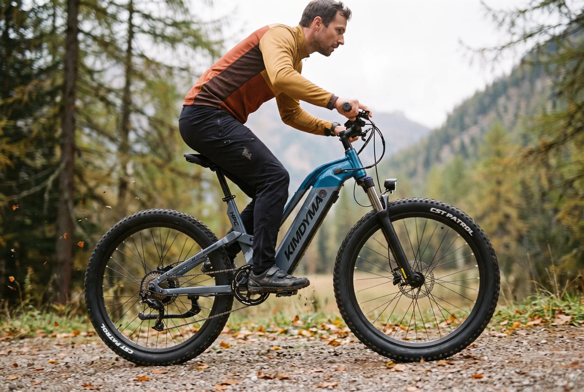 Electric mountain bike with suspension fork riding a gravel forest track in the Alps
