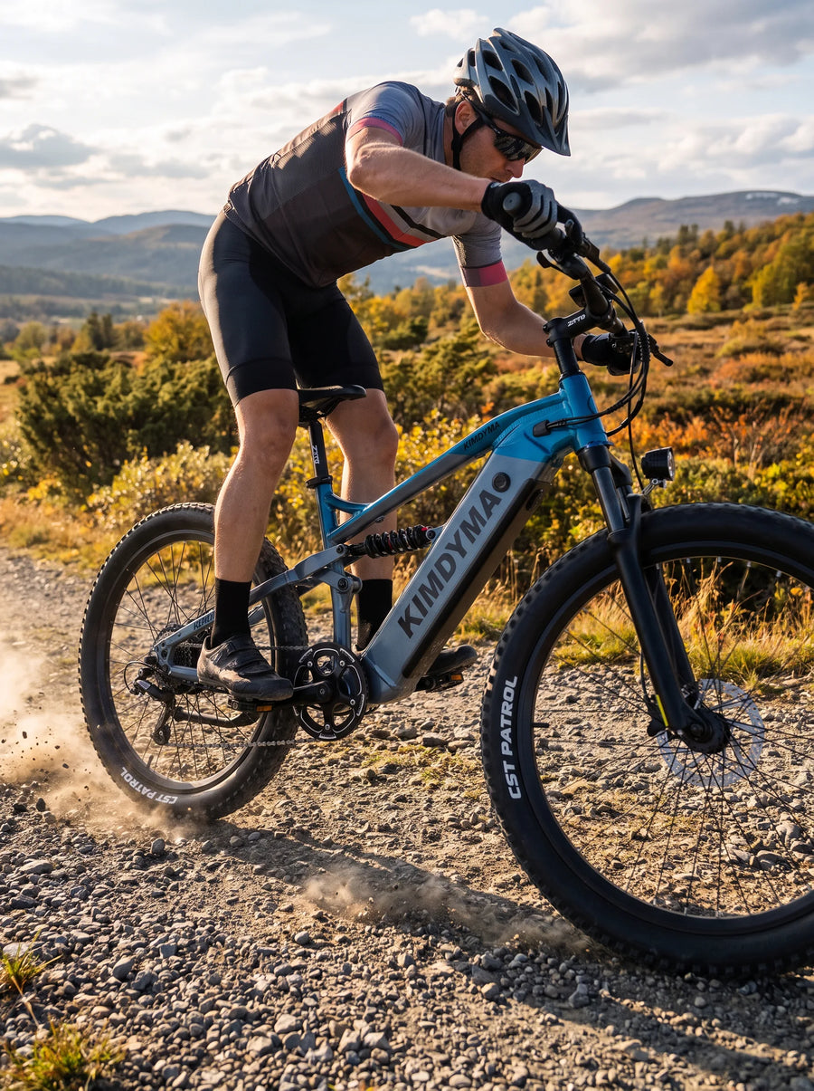 A cyclist riding a Kimdyma K01 electric mountain bike at high speed on a gravel road, kicking up dust and small stones,
