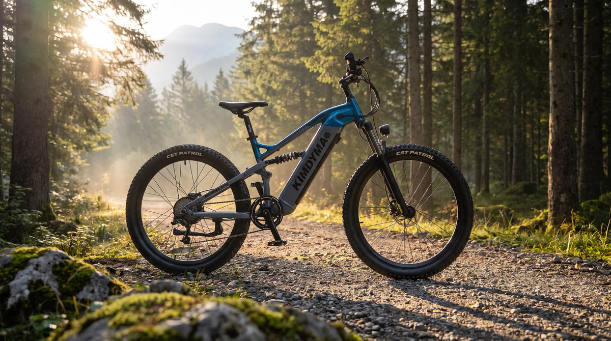 A Kimdyma all-terrain electric mountain bike parked on a forest gravel trail, side profile showing the full frame agains