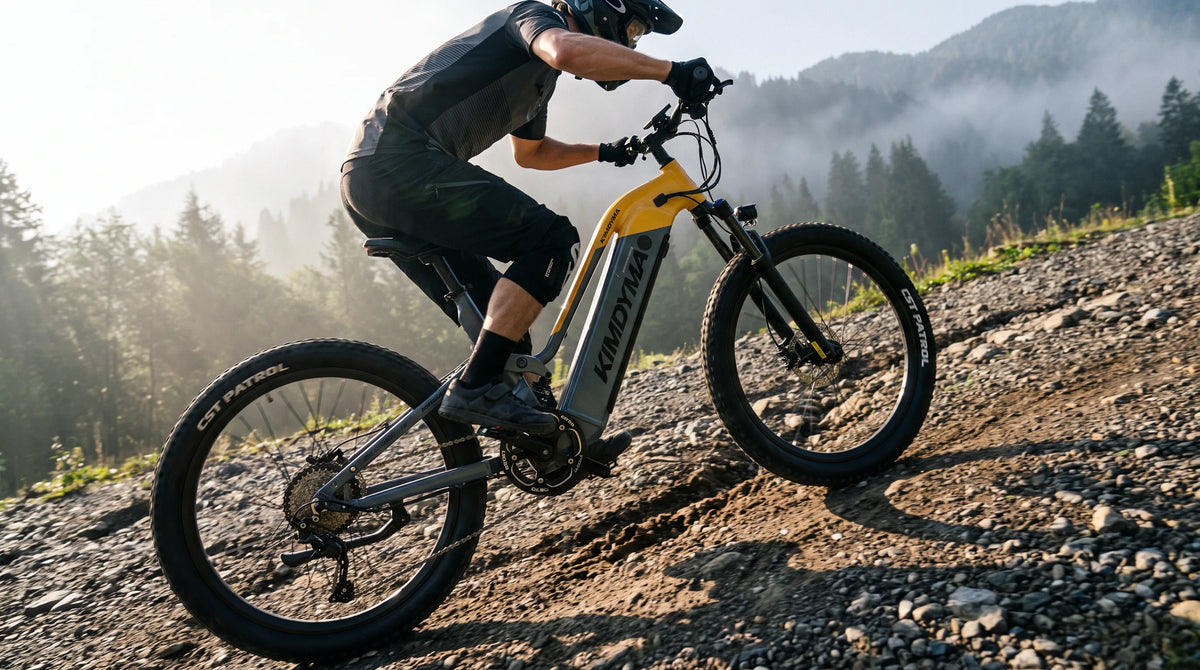A cyclist riding a Kimdyma K02 e-MTB uphill on a steep gravel trail at approximately 30-degree gradient, morning sidelig