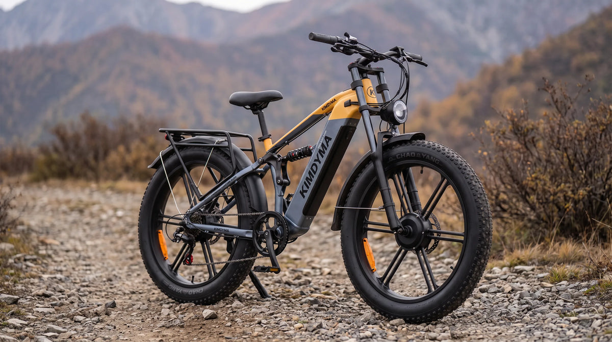 A Kimdyma K03 all-terrain e-MTB with dual hub motors and fat tires, parked on a gravel trail in a misty coniferous fores