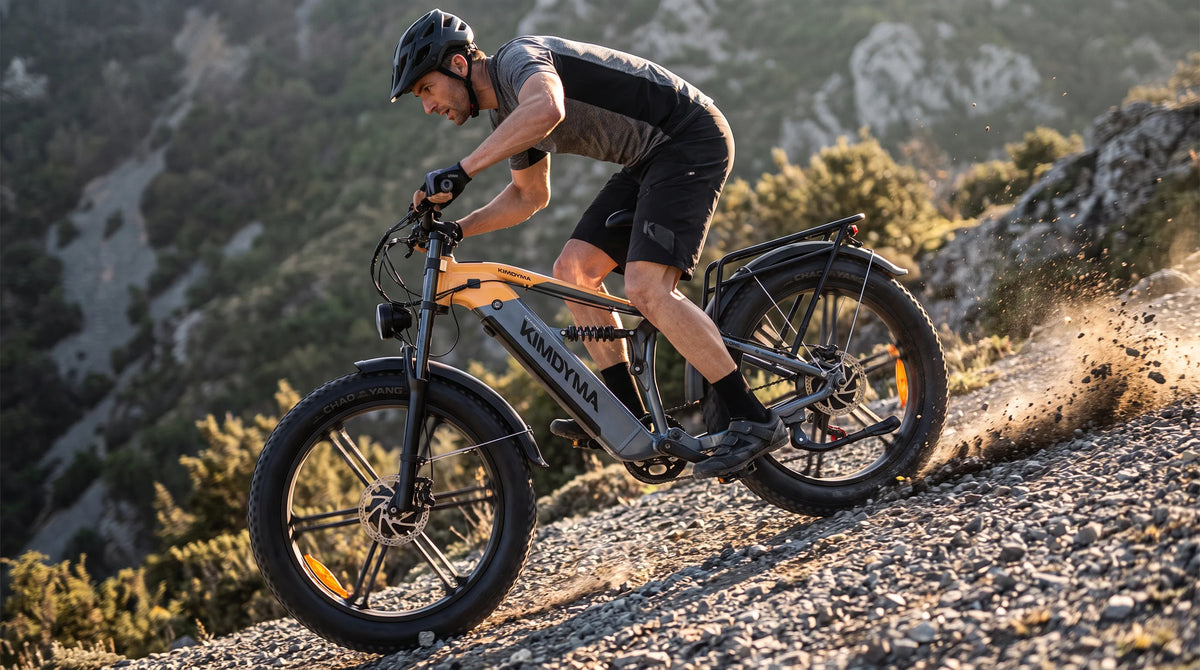 A tall male rider on a Kimdyma K03 e-bike climbing a steep mountain trail with gravel flying, demonstrating the dual-mot